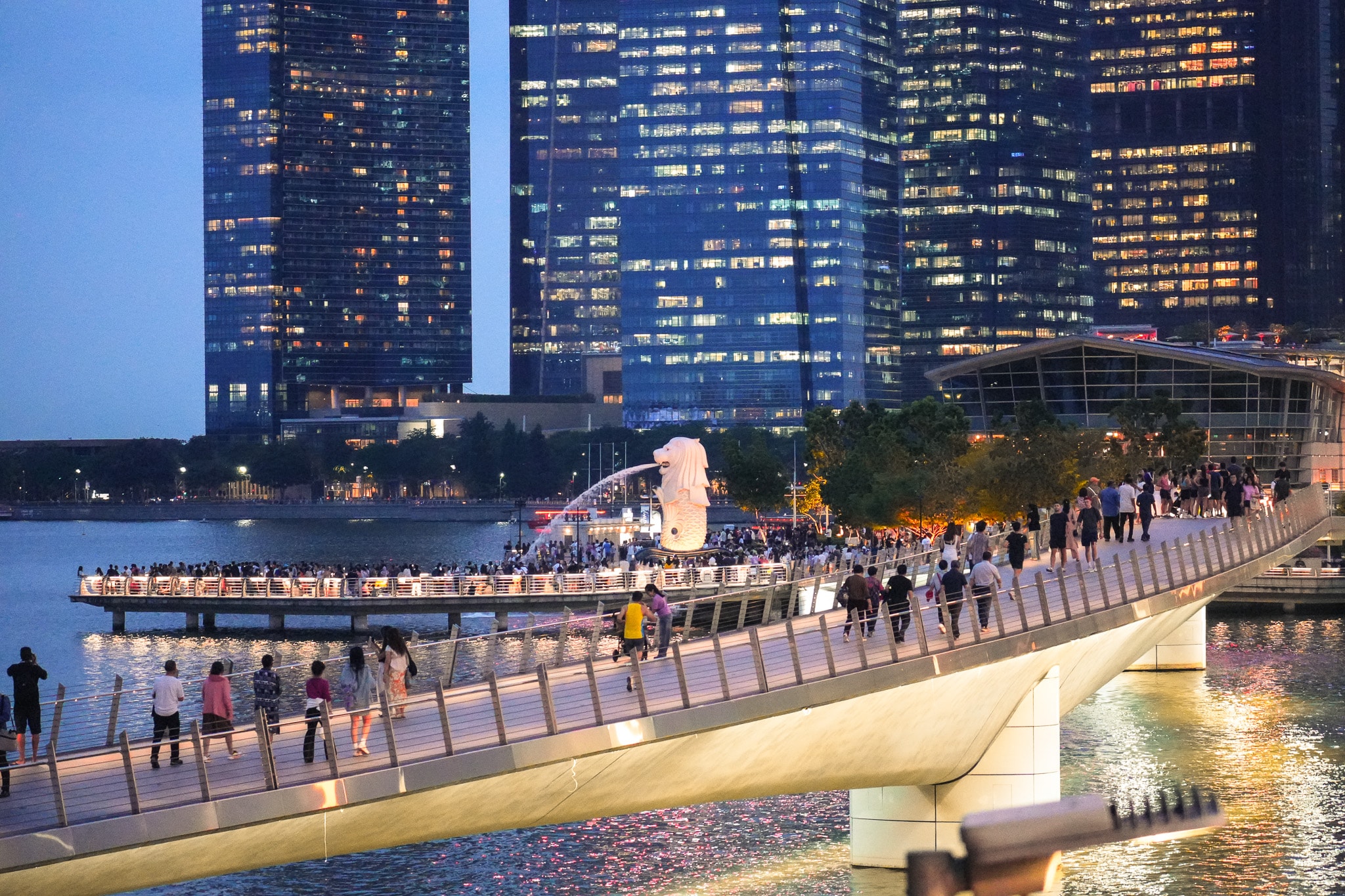 Waterfront promenade with illuminated skyscrapers