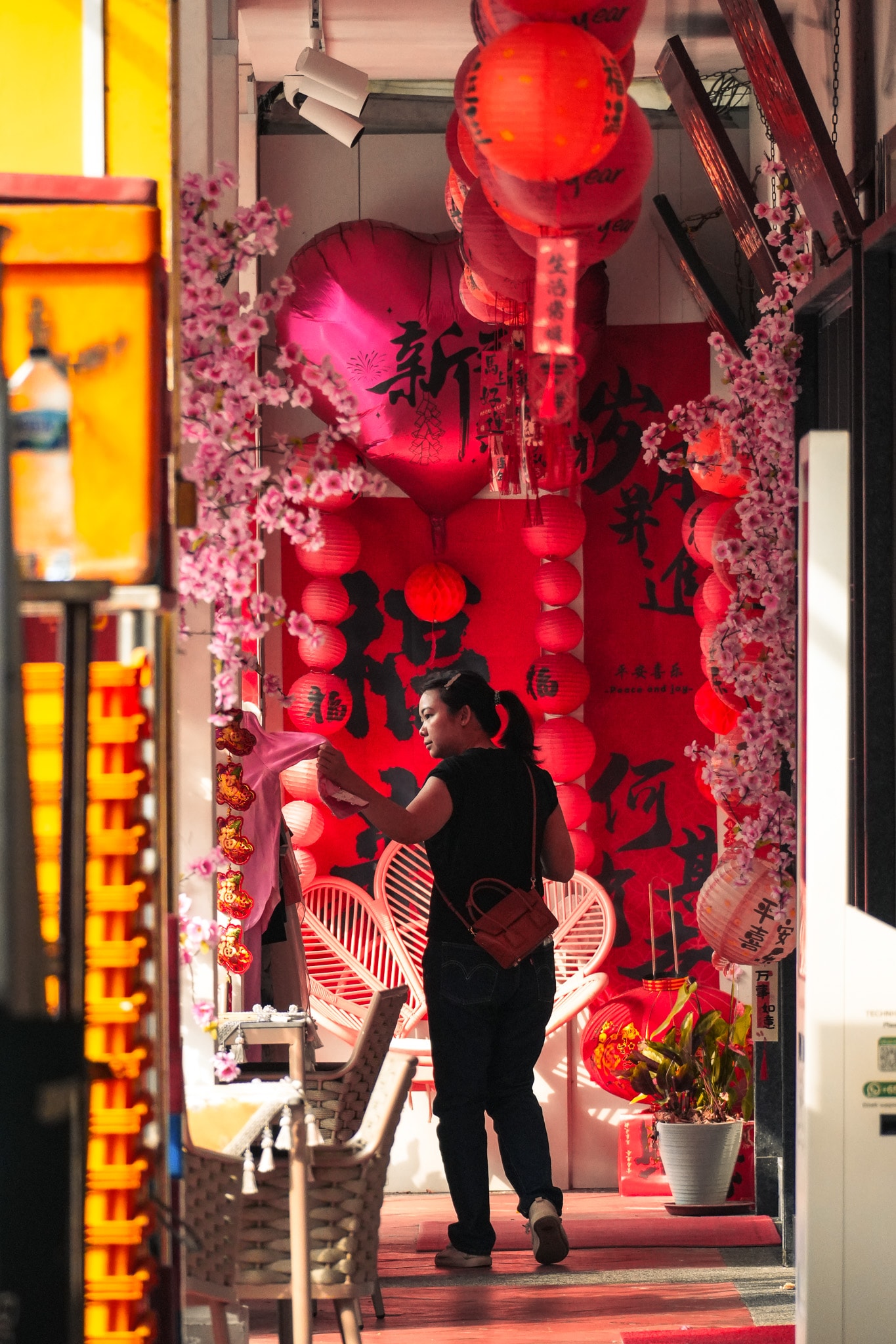 Woman in red lantern decorated alley