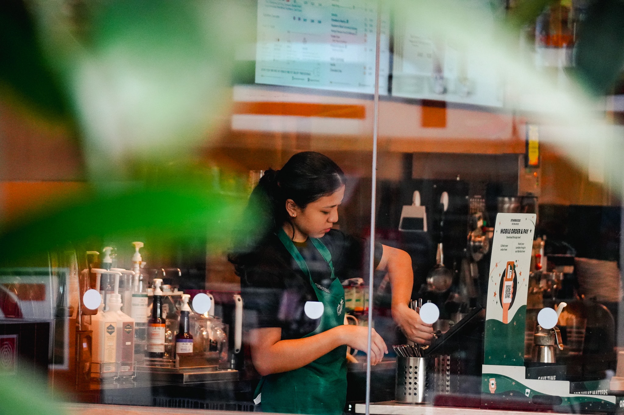Retail worker arranging products at store counter