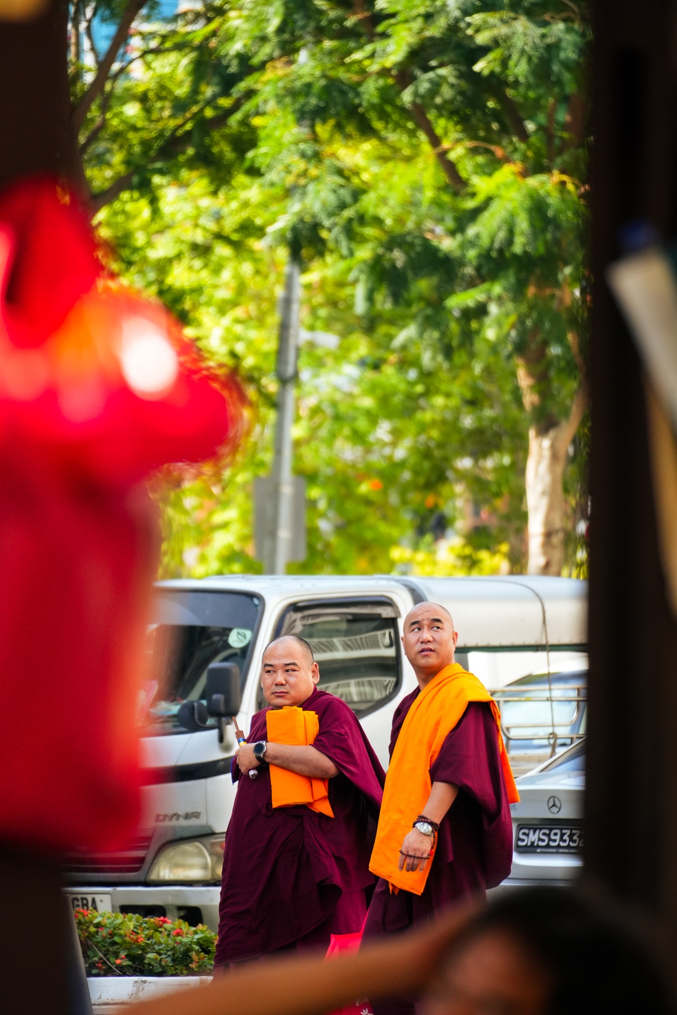 Buddhist monks in maroon robes standing
